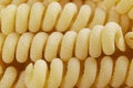 Macro shot of Yellow fusilli pasta background texture. Delicious pasta or fusilli noodles. Italian raw noodles. Homemade dry noodl Royalty Free Stock Photo