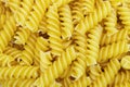 Macro shot of Yellow fusilli pasta background texture. Delicious pasta or fusilli noodles. Italian raw noodles. Homemade dry Royalty Free Stock Photo