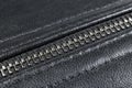 Macro shot of zipper on black leather texture background with stitching. Horizontal background from a close-up of black leather ma