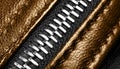 Macro shot of zipper on brown leather texture background with stitching. Horizontal background from a close-up of orange leather m Royalty Free Stock Photo