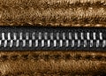 Macro shot of zipper on brown leather texture background with stitching. Horizontal background from a close-up of orange leather m