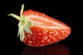 Macro side view of half of strawberry isolated on black Royalty Free Stock Photo