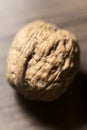 Macro of a single walnut in its shell on a rustic wooden surface, Royalty Free Stock Photo