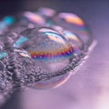 Macro of soap bubbles on a smooth surface reflecting soft colorful light Royalty Free Stock Photo