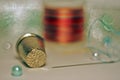 Macro still life with a thimble, coil, needle and thread.with blurred background and bokeh Royalty Free Stock Photo