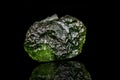 Macro stone mineral Moldavite on a black background