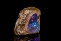Macro stone Opal mineral in rock on a black background Royalty Free Stock Photo
