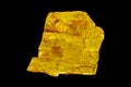 Macro stone Orpiment mineral on black background
