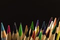 Macro studio shot of the color drawing pencils for creation, sharp tips close-up, black background with copy space photo Royalty Free Stock Photo