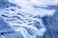 Macro texture of jeans hole and threads colored in classic blue Royalty Free Stock Photo