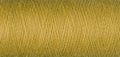 macro texture of a skein of yellow sewing thread