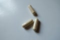 Macro of three beige capsules of Saccharomyces boulardii probiotic