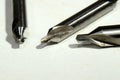 Macro of three center hole drills isolated on a white background