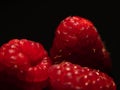 Macro three raspberries black background