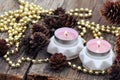 Candles With Cones And Beads On Wooden Table Royalty Free Stock Photo