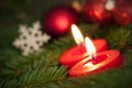 Macro of two Burning Candles with Christmas Background Royalty Free Stock Photo