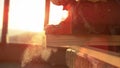 MACRO: Unrecognizable carpenter buffs the side of a plank with electric sander.