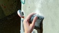 MACRO: Unrecognizable climber grips a gray edge hold with a chalked up hand.