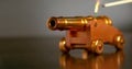 MACRO: Unrecognizable person lights up a loaded toy brass cannon with a match