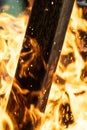 Macro vertical shot of a piece of wood burning in fire Royalty Free Stock Photo