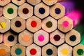 A macro of a very OCD orderly stack of unsharpened colored pencil ends from a mildly oblique angle showing a small segment of the