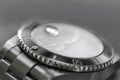 Macro, very shallow focus of part of a bezel on an iconic, swiss-made mechanical men`s diving watch.