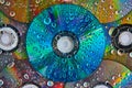 Macro of vibrant blue CD surface with water drops stacked on top of pile of CDs abstract art Royalty Free Stock Photo