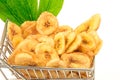 Banana chips with green leaves in metal trolley