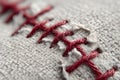 Macro view of a baseball showing red stitches winding through the textured fabric surface Royalty Free Stock Photo