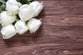 Macro view of beautiful white roses bouquet on the corner of the wooden table. Romantic wallpaper for beloved couples