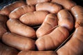 macro view on big pile of uncooked short thick sausages