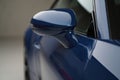 Close-up of blue car side mirror and door with glossy paint and reflective finish Royalty Free Stock Photo
