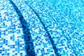 Macro view of blue tiled steps in swimming pool