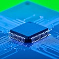 High-Tech CPU Microchip on a Blue Circuit Board Royalty Free Stock Photo