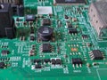 Macro view of a complex green printed circuit board with electronic components Royalty Free Stock Photo
