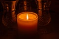 Macro view of a glowing candle flame in a darkened room
