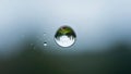 Macro view of landscape reflected in water droplet against blurred background Royalty Free Stock Photo