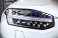 Macro view of modern car headlight SUV with noise graine effect. car xenon lamp headlight. detail view on car xenon lamp