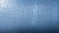Macro view of numerous water droplets on a blue glass surface Royalty Free Stock Photo