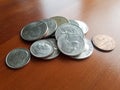 Pile of US currency Liberty quarter and other coins on wood table Royalty Free Stock Photo