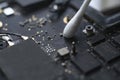 a macro view of removing dust from microprocessor board using the cotton bud