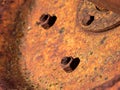 Macro view of a rusty nut on a grungy old bolt on a weathered machinery metal sheet Royalty Free Stock Photo