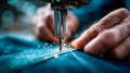Macro view of a sewing machine stitching denim fabric as sparks fly from the needle area Royalty Free Stock Photo