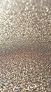 Macro of shimmering golden glitter particles creating a sparkling bokeh effect with soft focus and warm light highlighting the Royalty Free Stock Photo