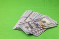 Macro view of spread out stack of dollars isolated on green background Royalty Free Stock Photo
