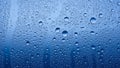 Macro view of water droplets on a blue glass surface Royalty Free Stock Photo