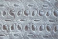 Macro of white eyelet embroidery cotton fabric