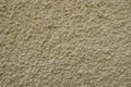 Macro of wall with light beige roughcast finish