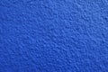 Macro of wall with coarse blue roughcast finish