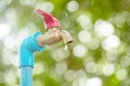 Macro water faucet with one water dripping in garden with green nature bokeh and blur Royalty Free Stock Photo